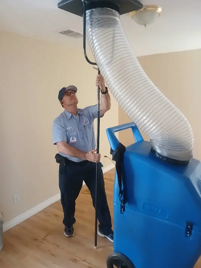 Furnace Tune-Up technician using HEPA equipment in Toledo